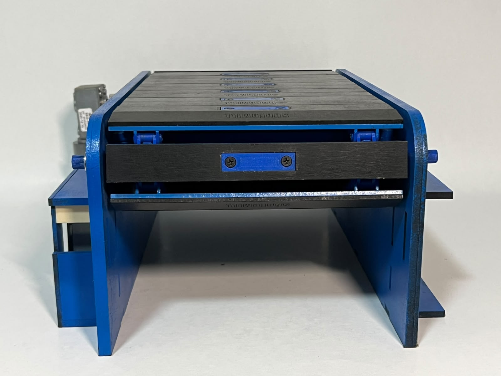 Rear view of the blue Shredmill base showing the roller and frame