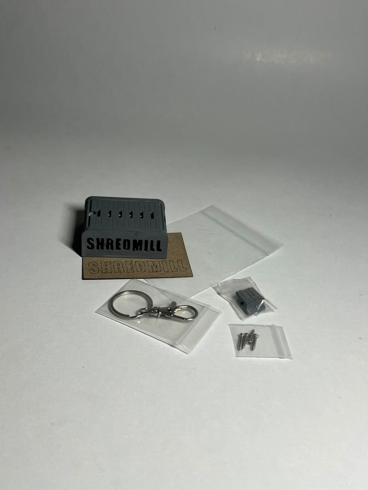 Shredmill keychain and its components before assembly