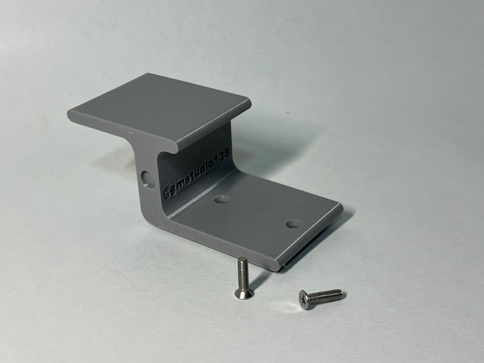 Second view of the gray interchangeable Shredmill obstacle and its two screws